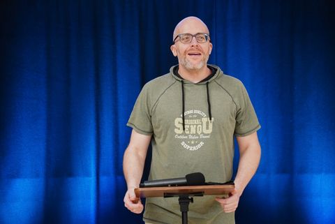 Richard preaching on stage at GraceLink Church