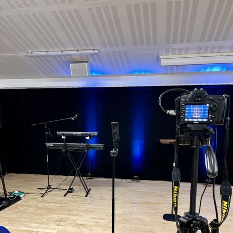 The GraceLink Church stage set up with instruments, camera and lighting ready for Sunday service